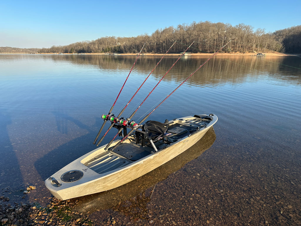 Fishing kayak on a calm lake with trees in the background